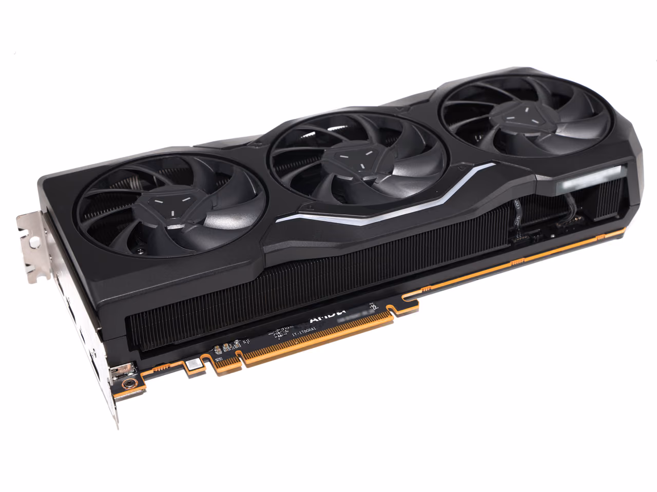 A Sapphire Radeon RX 7900 XTX at an angle against white: a black three-fan shroud with a silver stripe along its spine, a finned heatsink beneath it, the bracket at the left and gold PCI Express contacts below.