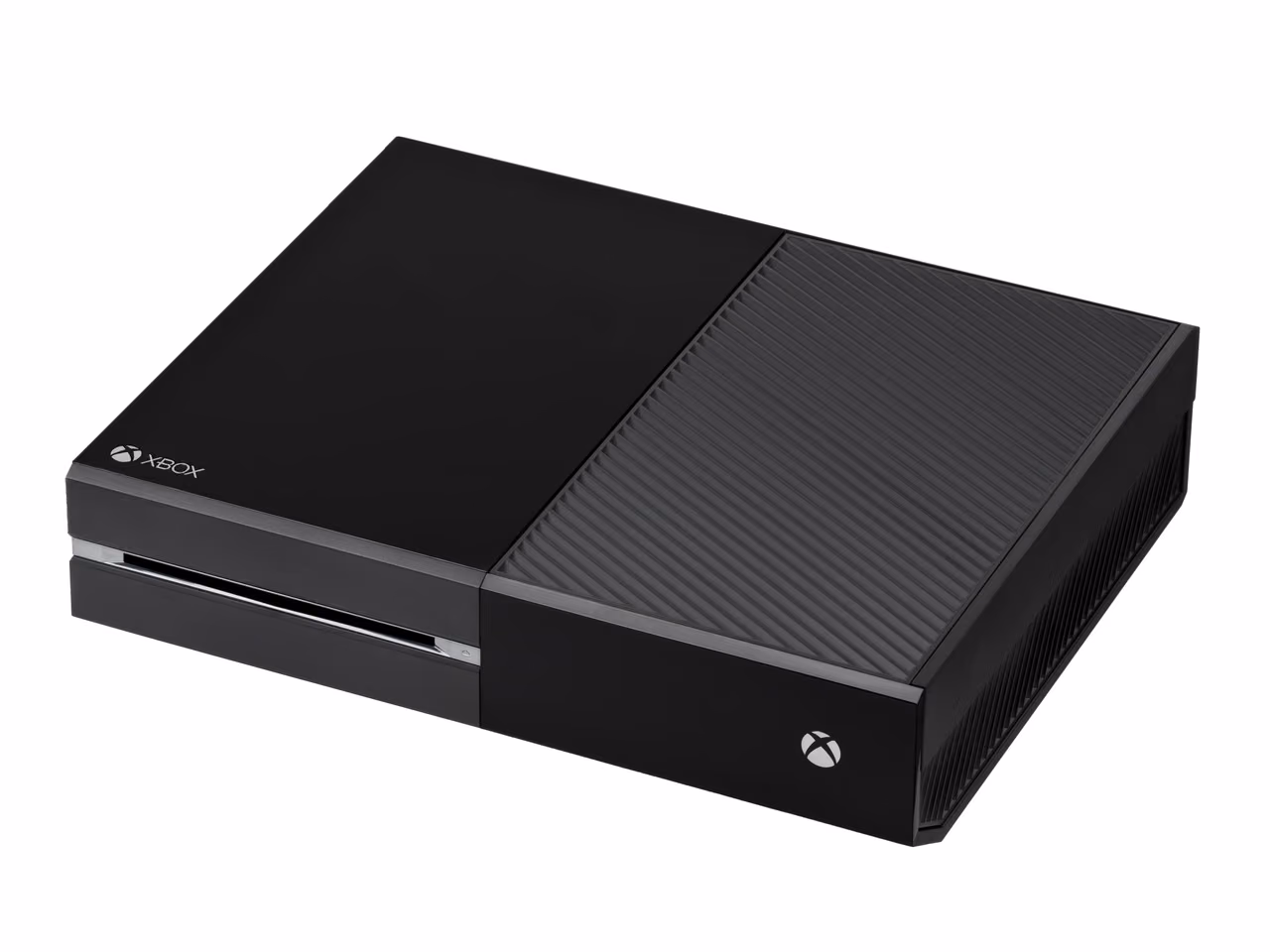 A black Microsoft Xbox One lying flat and photographed against white, half of its top surface gloss and half ridged matte, with a slot-loading disc drive on the left of the front face.