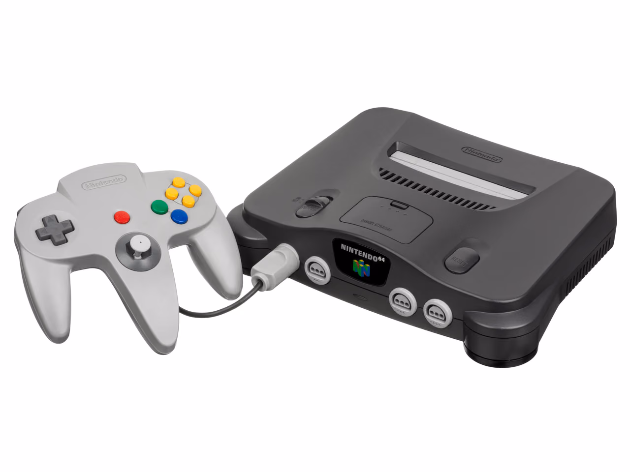 A dark gray Nintendo 64 photographed against white, its cartridge slot open on top and three controller ports across the front, with the gray three-handled controller to its left.