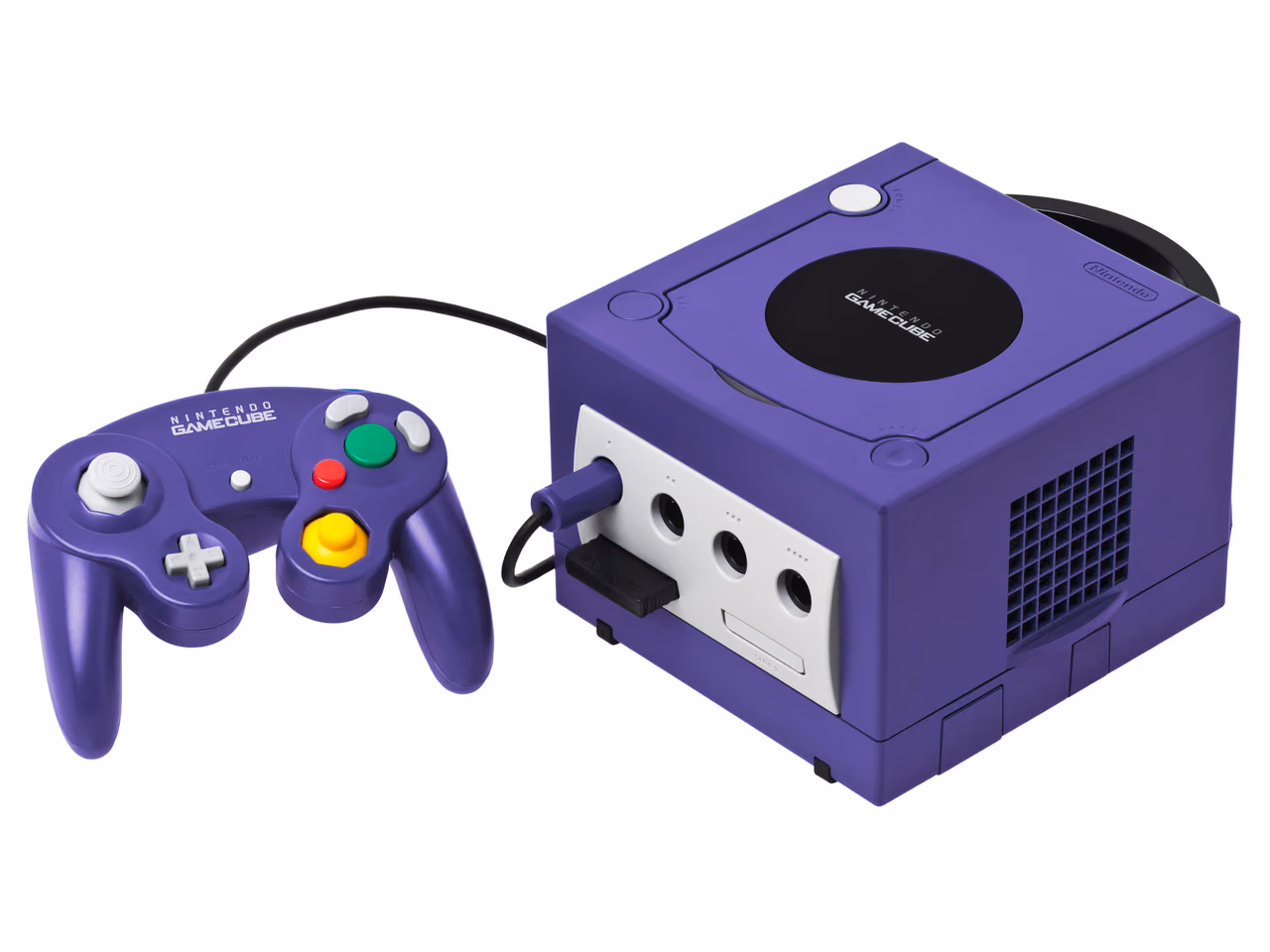 A purple Nintendo GameCube photographed against white, a cube with a carrying handle at the back and a circular disc lid on top, a memory card in a front slot, and a purple controller to the left.