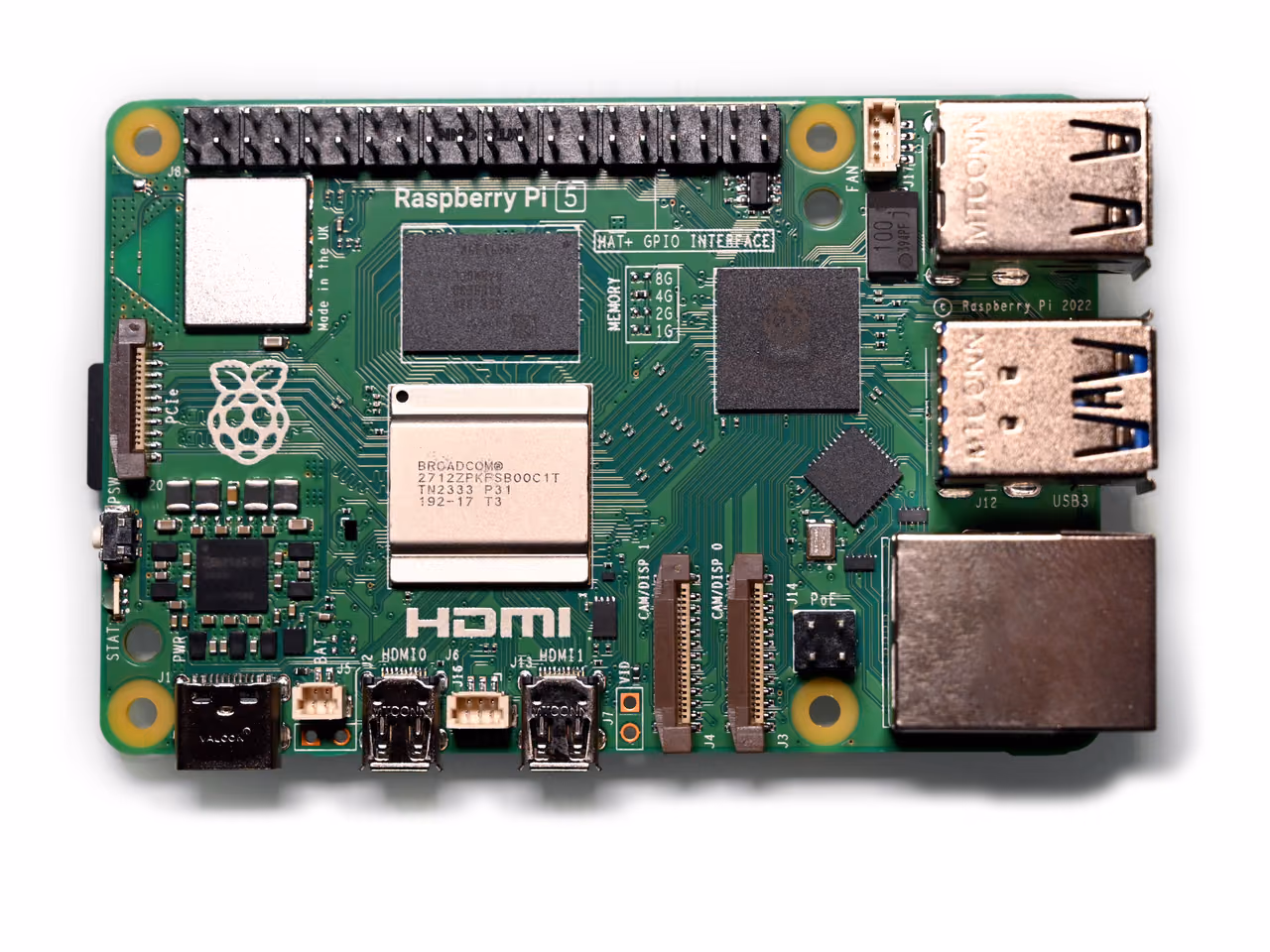 A green Raspberry Pi 5 board photographed from above against white, with a black forty-pin header along one edge, two stacked USB pairs and an Ethernet socket.