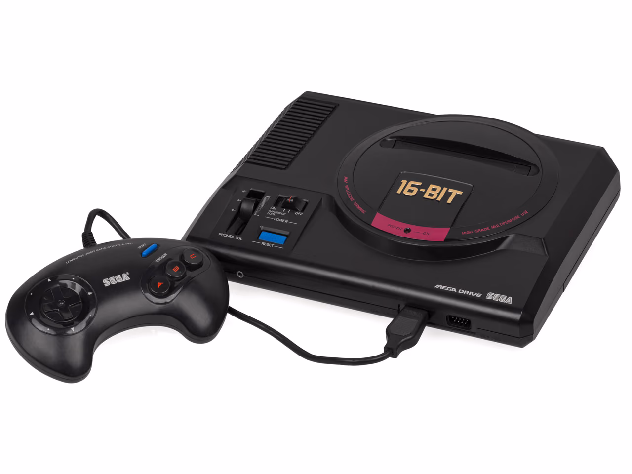 A black Japanese Sega Mega Drive photographed against white, a round cartridge lid marked 16 bit set into its top, volume and power switches on the left, and a three-button control pad in front.